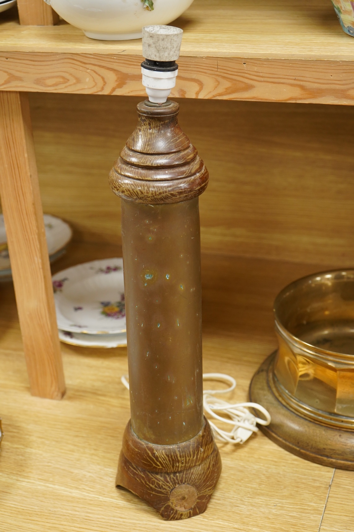 A bronze spitoon on plinth and a near pair of cartridge case table lamps, largest 46cm high